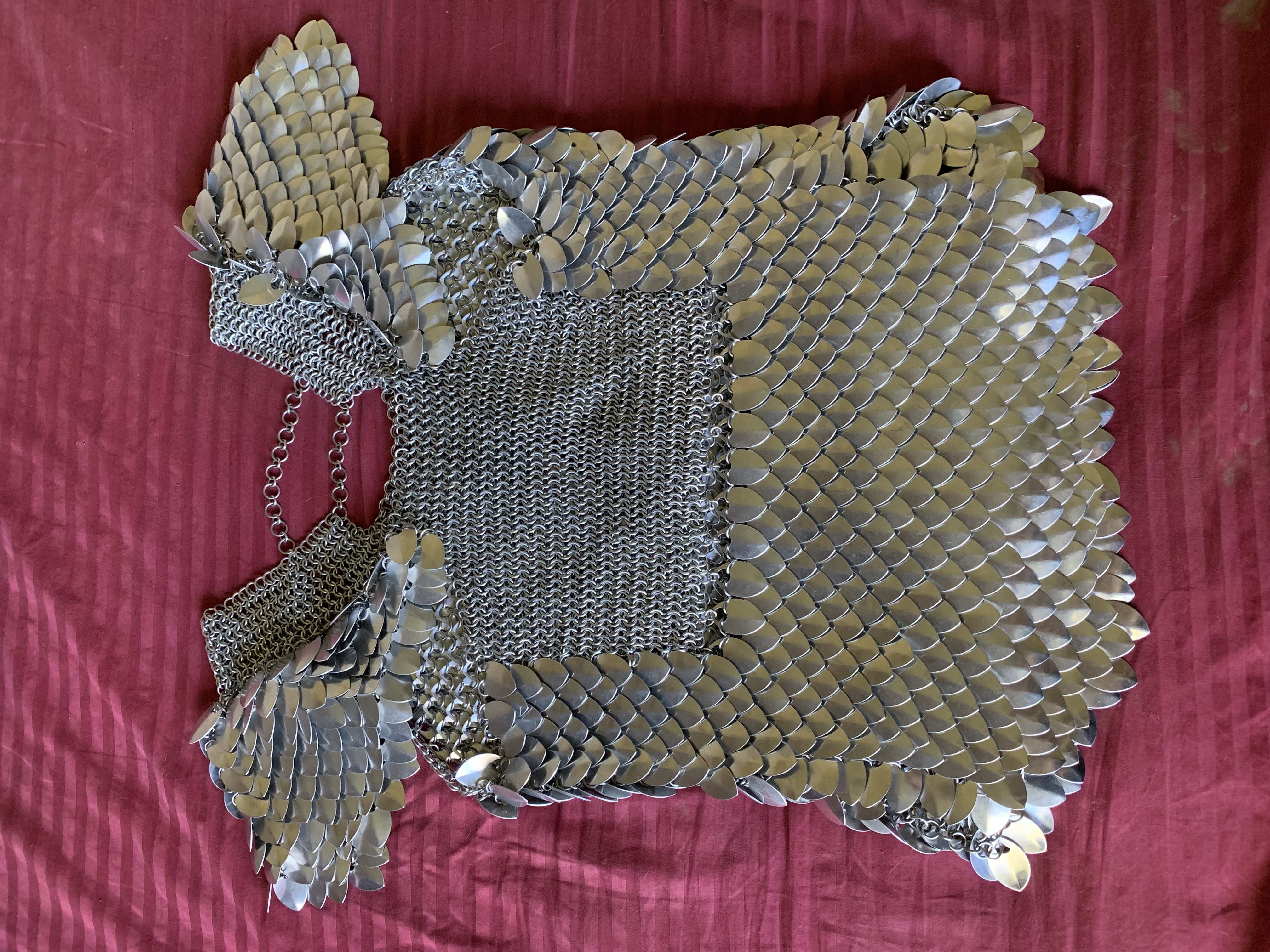 the back of a mostly completed scale maille shirt