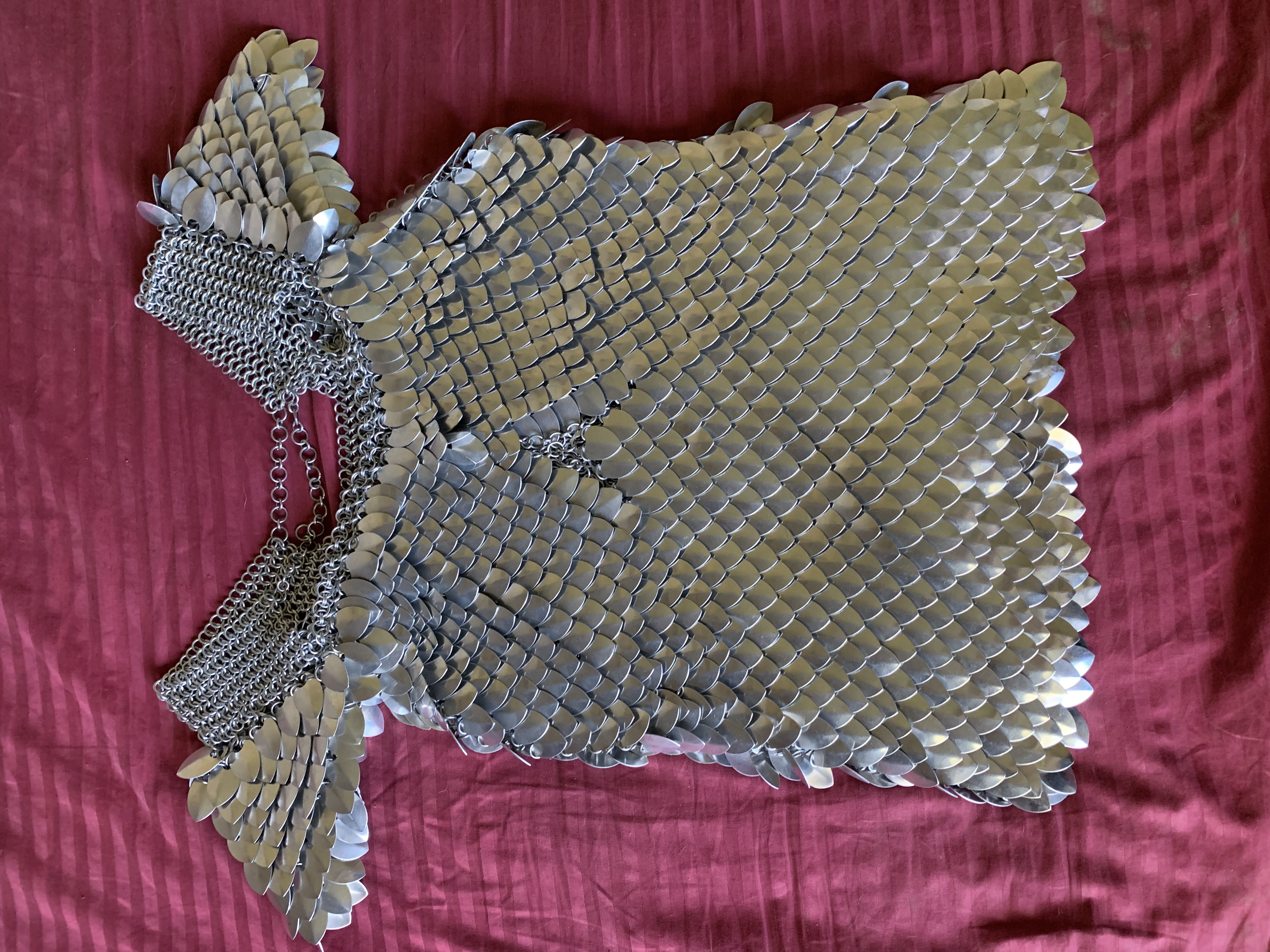 the front of a mostly completed scale maille shirt